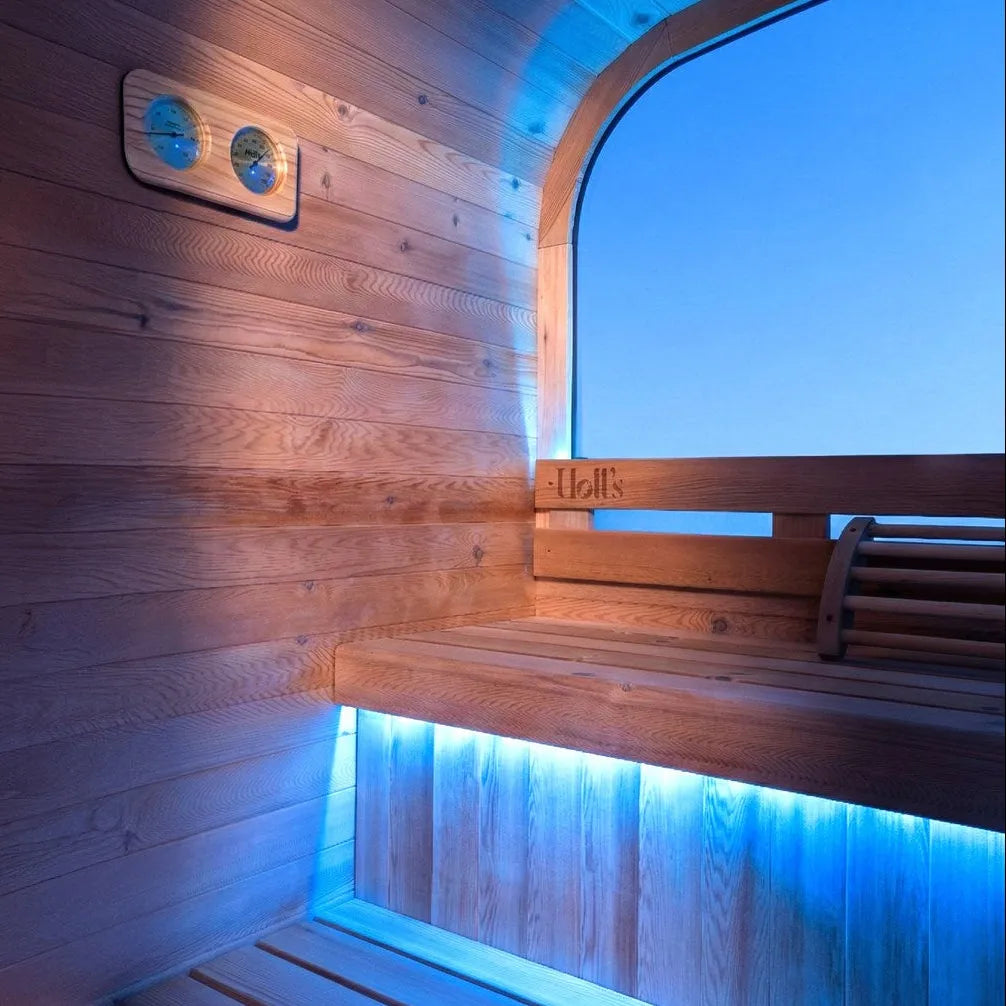 Holl's Hestia 160 outdoor sauna interior with blue LED bench lighting and porthole window