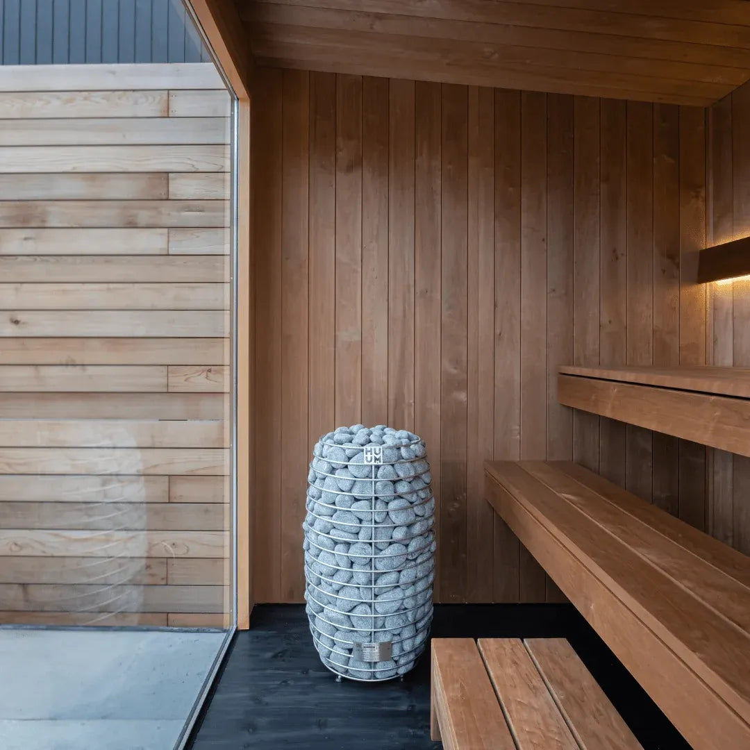URSA interior detail: the heater and its stone column beside the benches