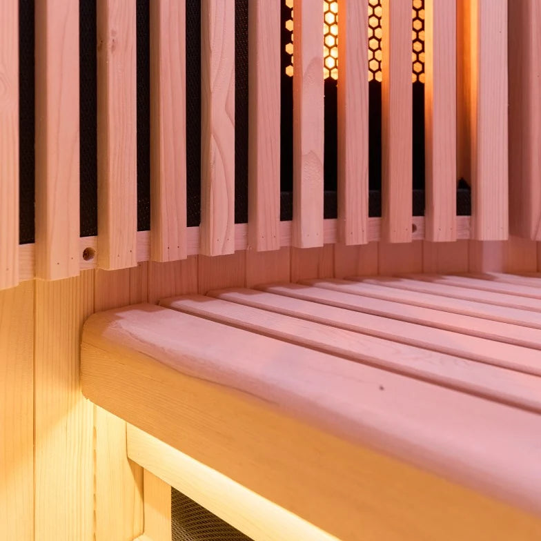Close-up interior of a Holl's Moon 1 wooden sauna cabin with a curved exterior