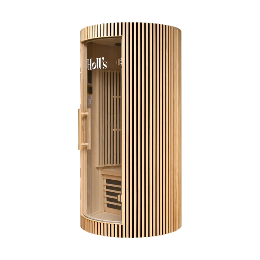A modern cylindrical Holl's Moon 1 wooden sauna cabin with a curved exterior wooden sauna cabin with vertical slat paneling and a glass door