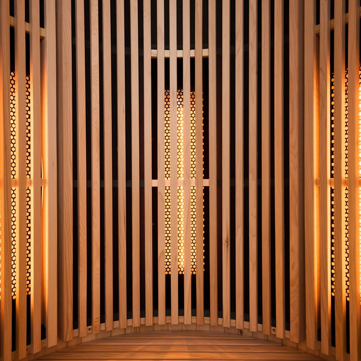 Wooden interior with vertical slats and warm orange light glowing through the slats.