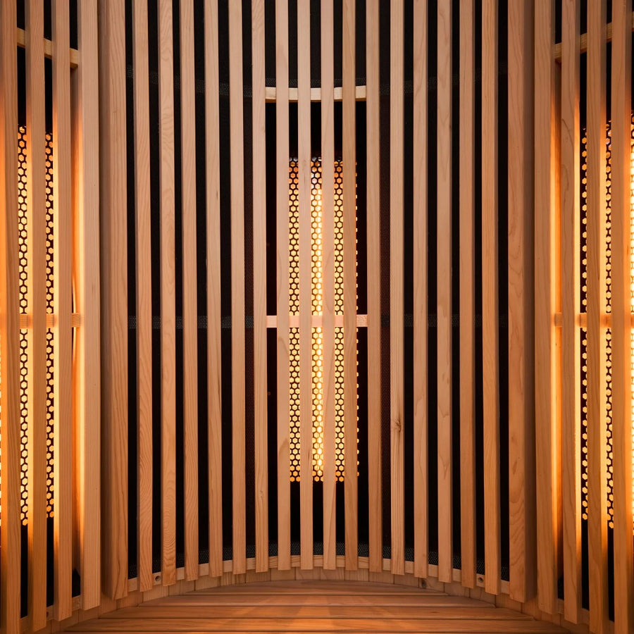 Wooden interior with vertical slats and warm orange light glowing through the slats.