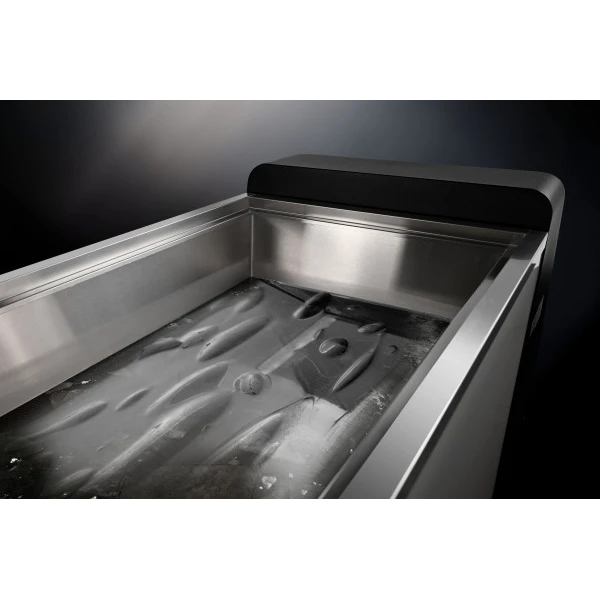 The stainless steel interior of the IceFall Ice Bath, filled with water and ice.