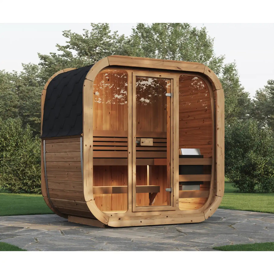 ICON 125 cube sauna on a paved base in a garden, full height glass front with the door set into it, black shingle roof
