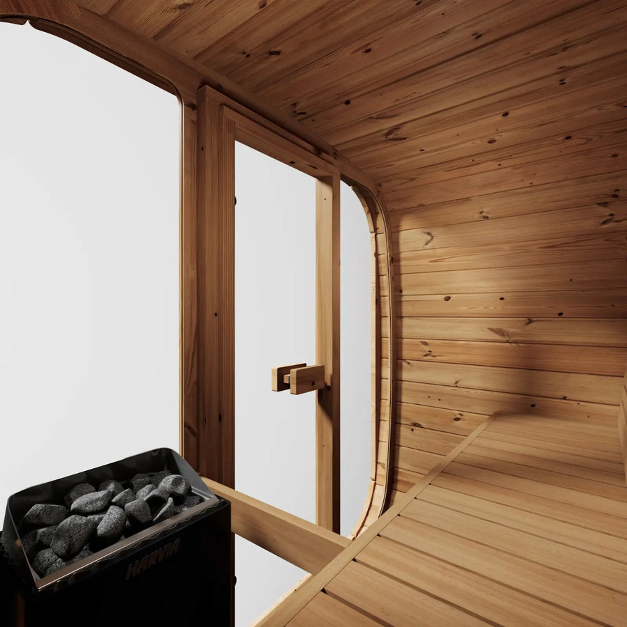 Inside the ICON 125, the heater beside the glass door with its stones loaded, bench to the right