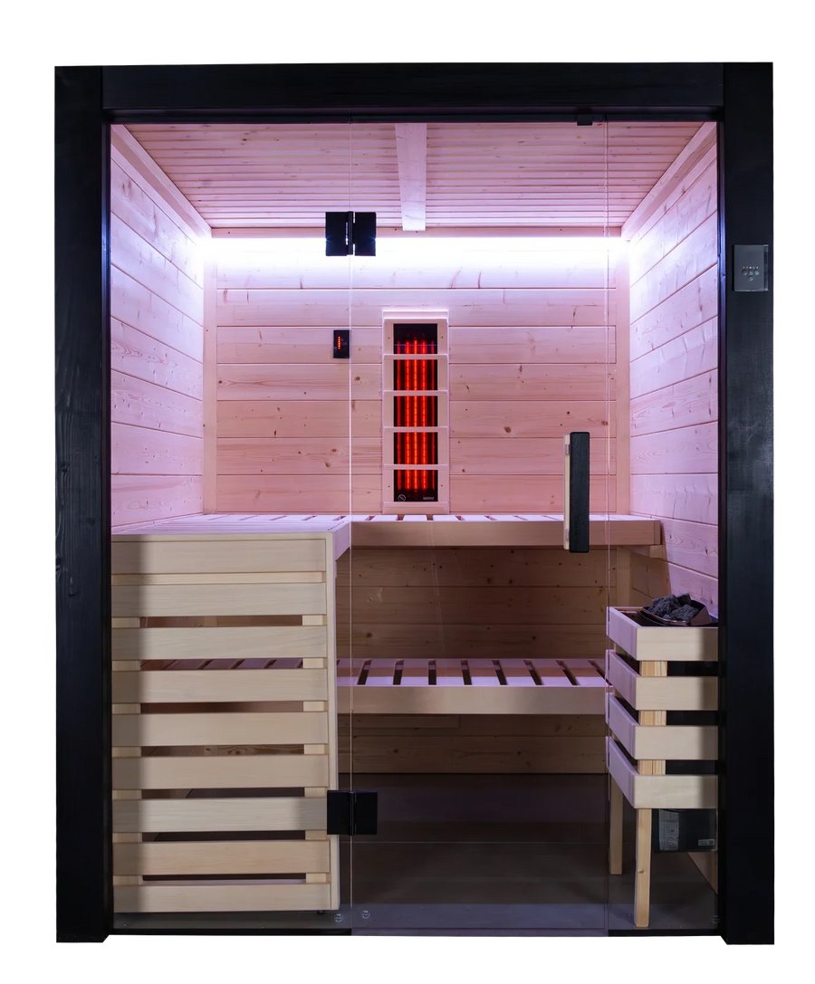 Front view of the cabin showing the L shaped benches, the corner heater with stones and the VitaMy infrared radiator