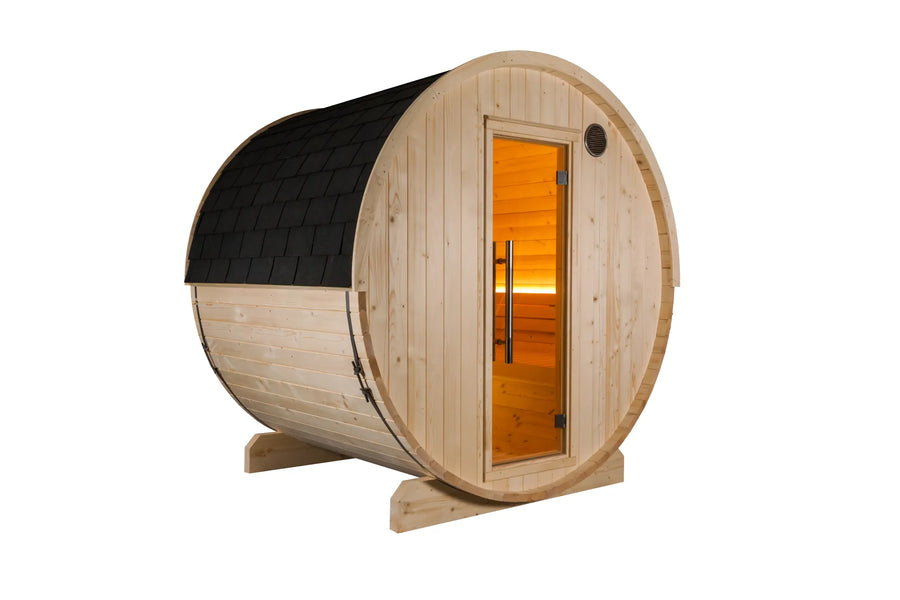 Harvia Kuusi 180 barrel sauna in untreated spruce with a black shingle roof, seen from the front with the glass door and the interior lit