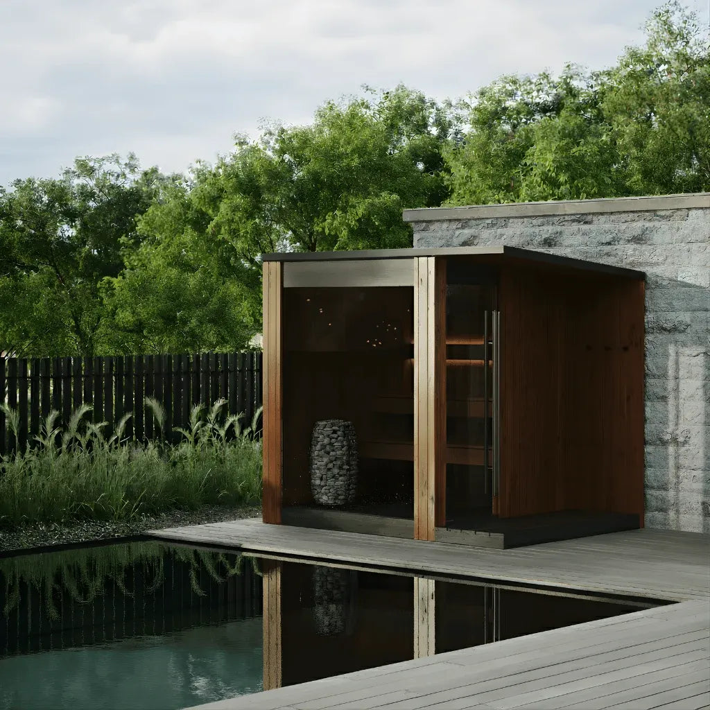 URSA three to four person outdoor sauna in natural thermo pine beside a garden pool