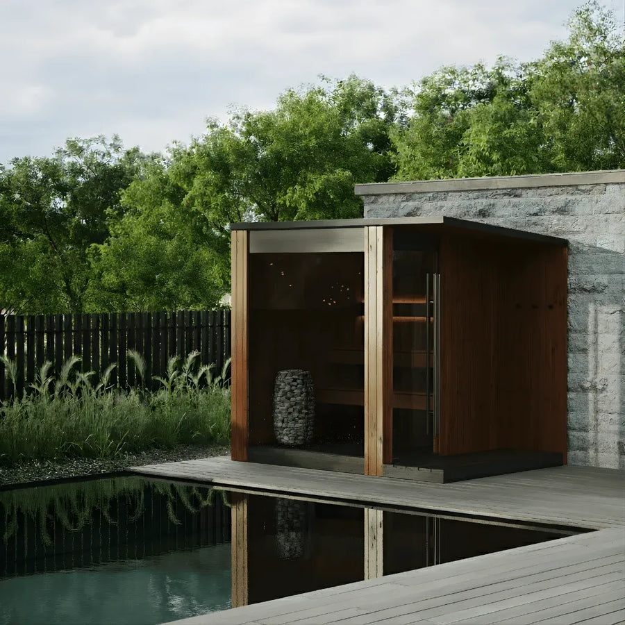 URSA three to four person outdoor sauna in natural thermo pine beside a garden pool
